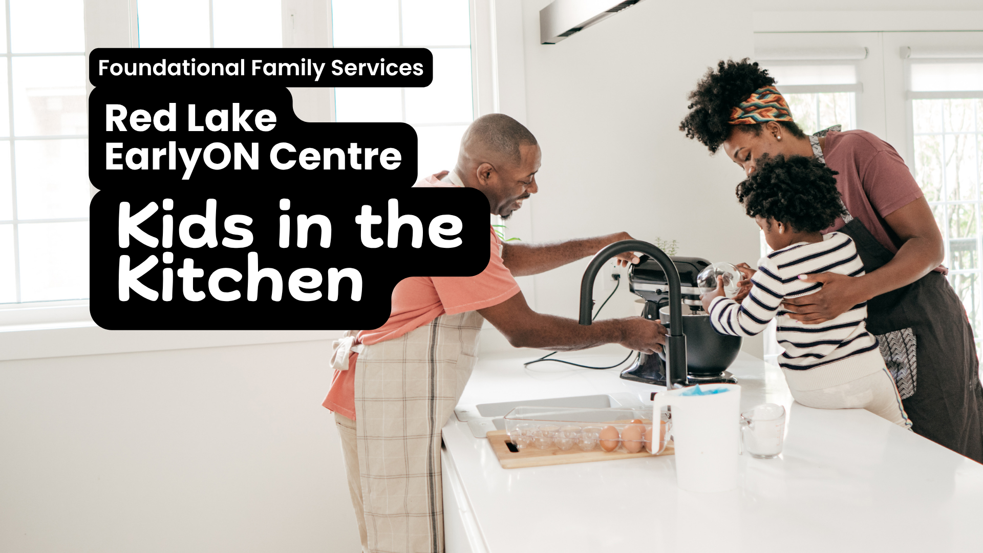 In white text on top of a black box Foundational Family Services, Red Lake EarlyON Centre, Kids in the Kitchen. Image in the background shows a mom and older child having fun in the kitchen. The mom, light skin with dark hair is pretending to sing into a spatula, while the kid, also light skin dark hair, has put a colander on their hair and has a huge smile.