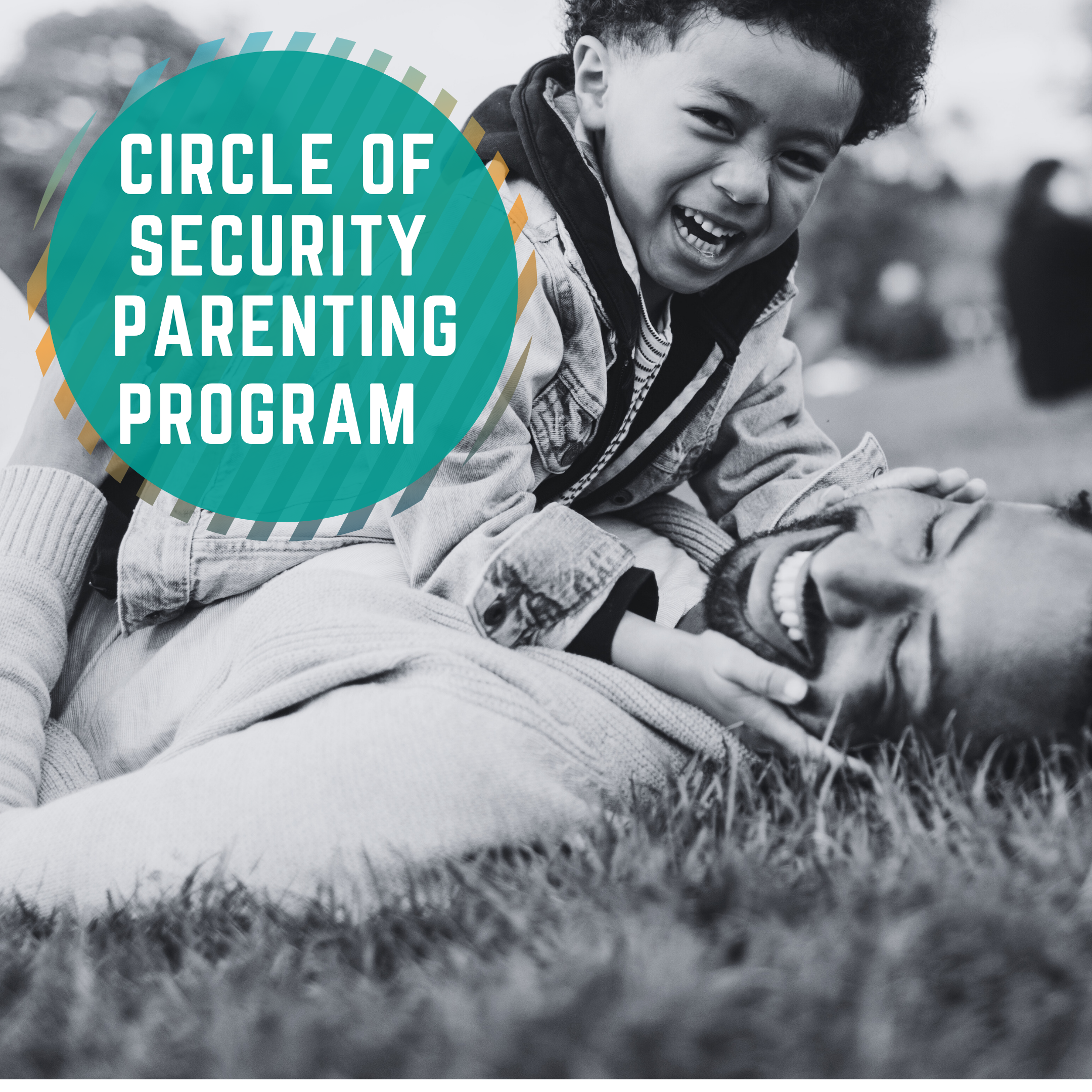 Circle of Security Parenting Program. An image of a young boy playing with his Dad on the grass. They are both laughing and rolling around.